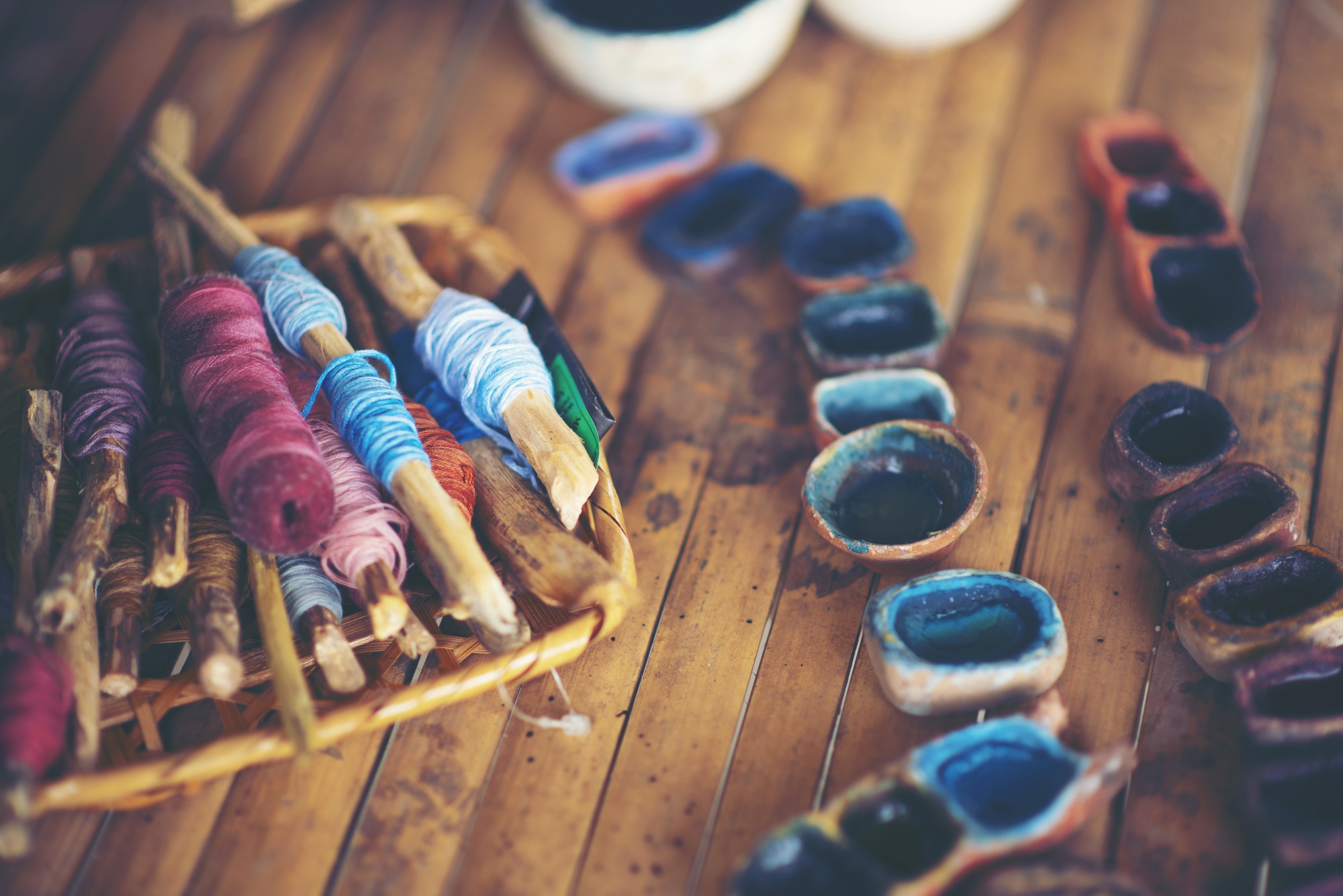 Artisan arranging threads at workbench